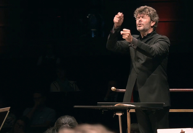 Man conducting with intense. From the concert.