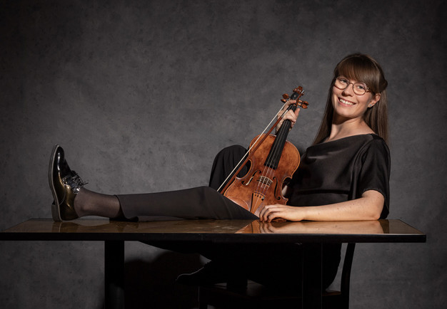 Picture of a smiling woman with a viola..