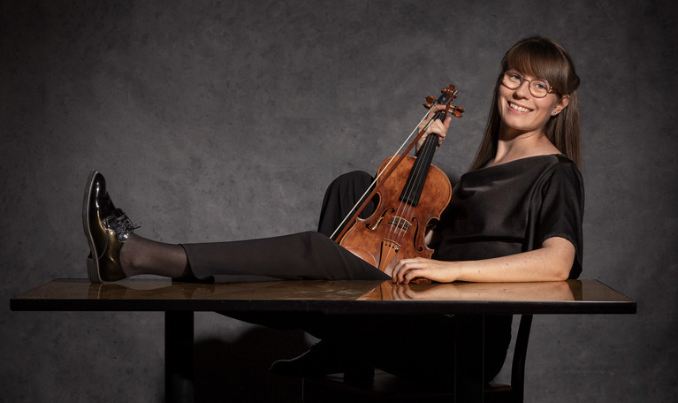 Picture of a smiling woman with a viola..